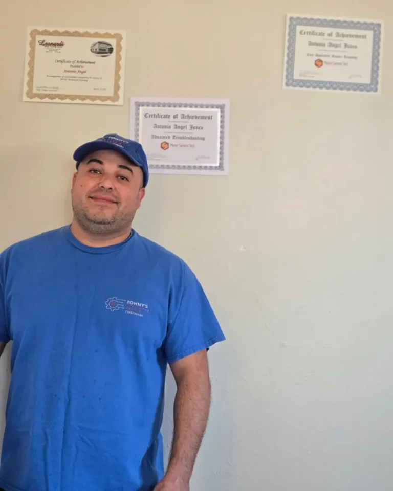 Appliance Repair 80 Tony Junco, owner of Tonny's Appliance Repair, in front of his appliance repair training certificates