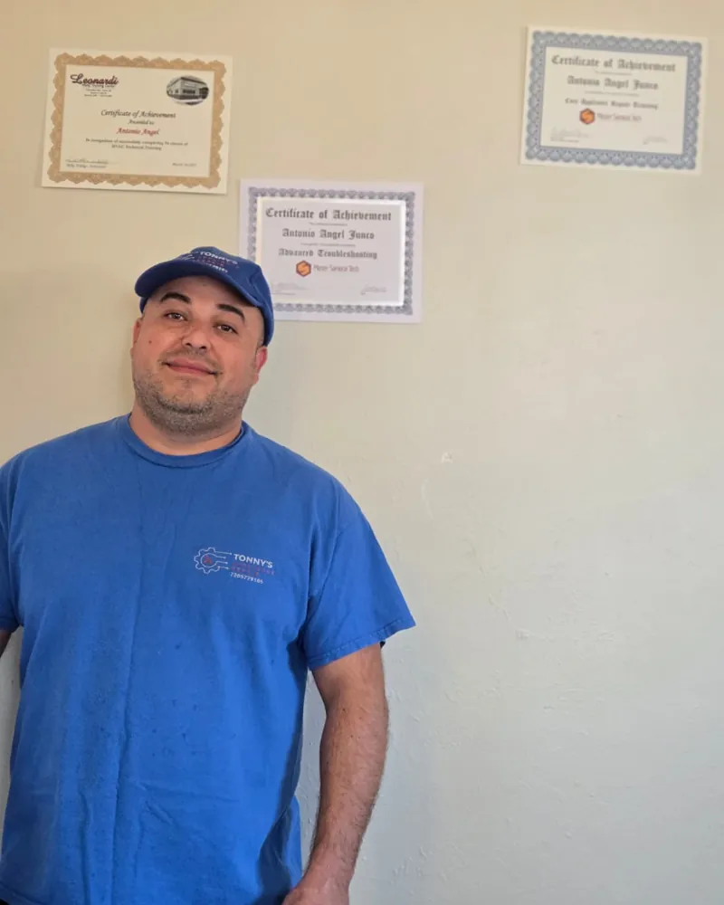 Appliance Repair 80 Tony Junco, owner of Tonny's Appliance Repair, in front of his appliance repair training certificates